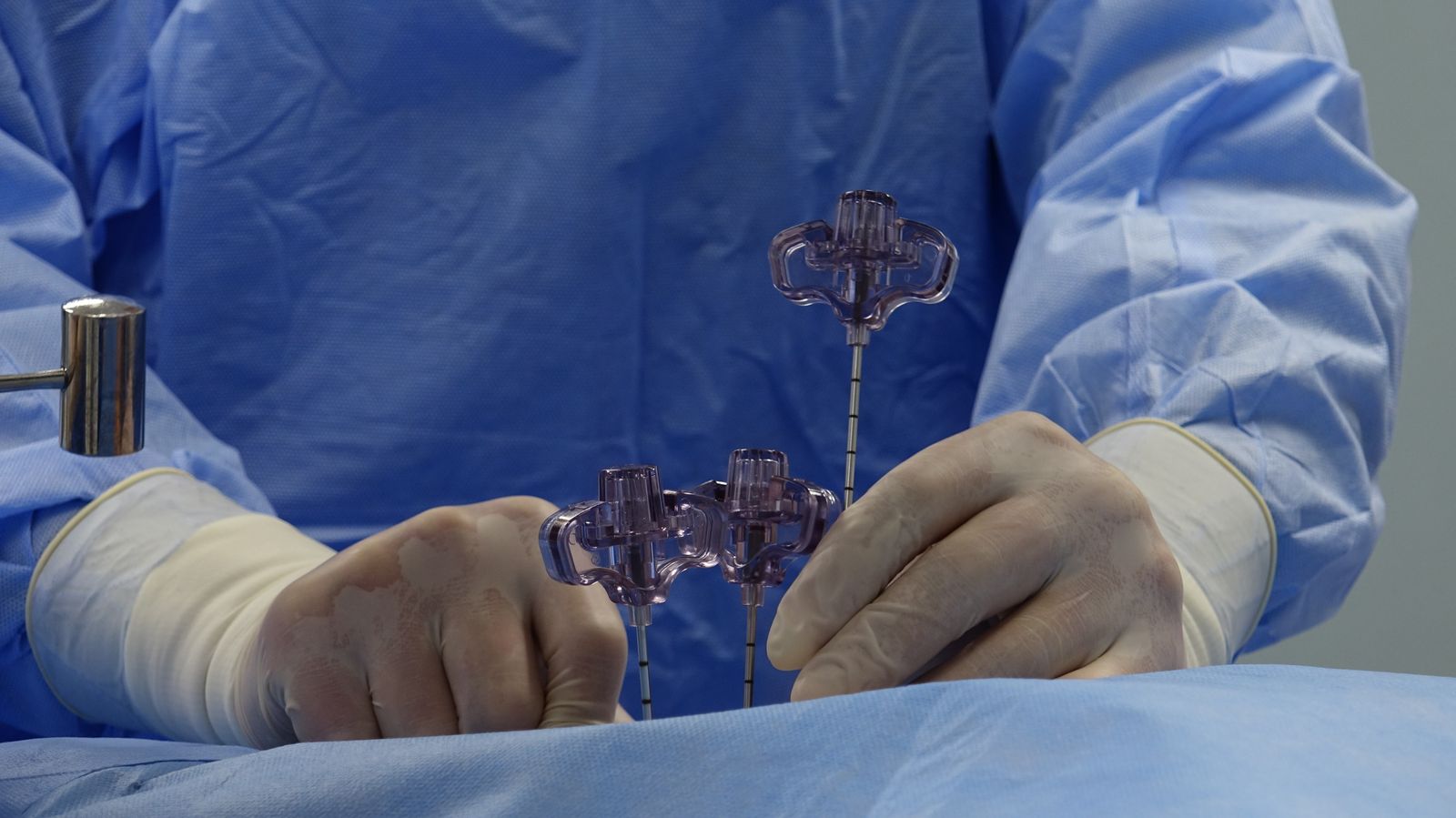 Surgical team working with spinal instrumentation in an operating room.